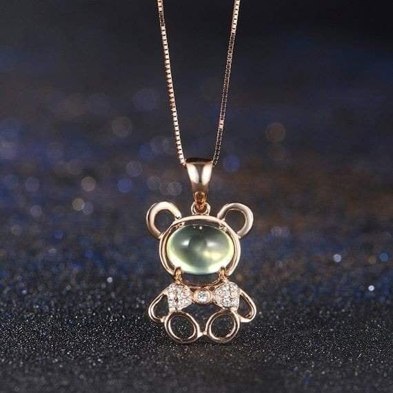 58 Pendant in the shape of a mouse with a sphere in the middle, a shiny gold chain and brilliant strass