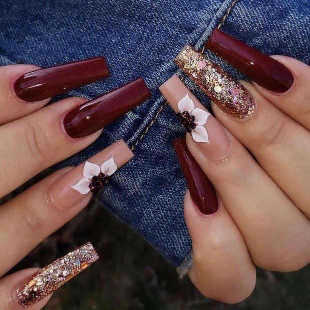 60 Long burgundy burgundy square tip nails with salmon enamel and white or black flowers, some with golden glitter