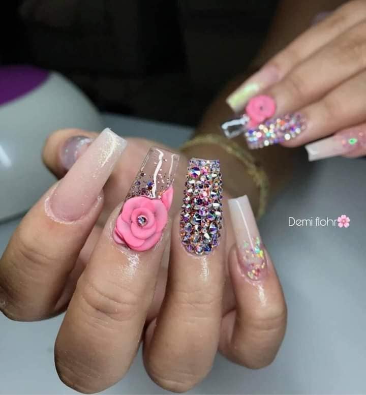 25 Nails with natural light pink drawings intense pink flowers with stones in the middle abundant rhinestones in a
