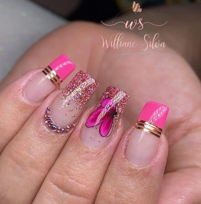 26 Colored Nails natural pink background intense pink tips glitter butterflies iridescent rhinestones parallel golden straps