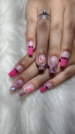 34 Fuchsia Colored Nails at the tips golden straps drawings of flowers and glitter
