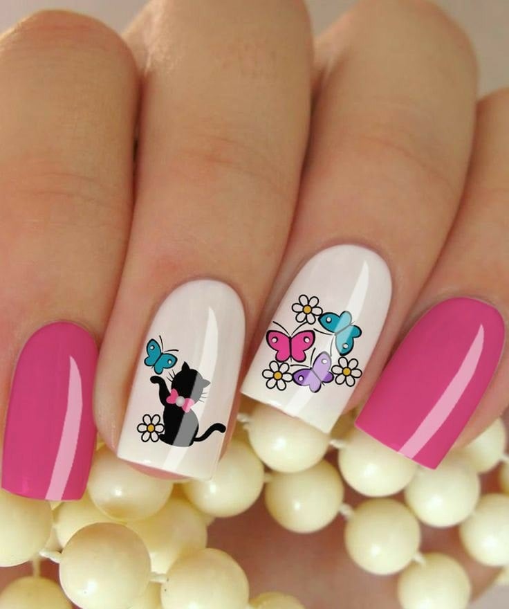 57 Nails Decorated with Fuchsia and White Flowers with a Drawing of a Black Kitten with a Blue Butterfly