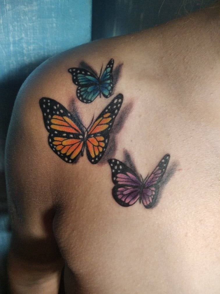 153 Most Liked Original Tattoos three butterflies three D orange blue and violet on clavicle