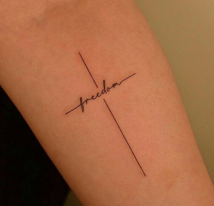 58 Simple Tattoos of Women Cross with word Freedom Freedom