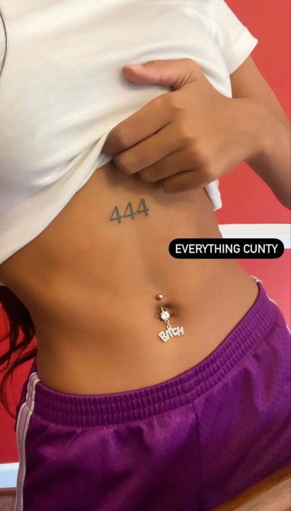 73 Dangling Belly Button Piercing with the Word Bitch Bitch