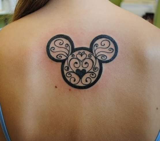 35 Mickey tattoos three circles and ornaments inside between the shoulder blades