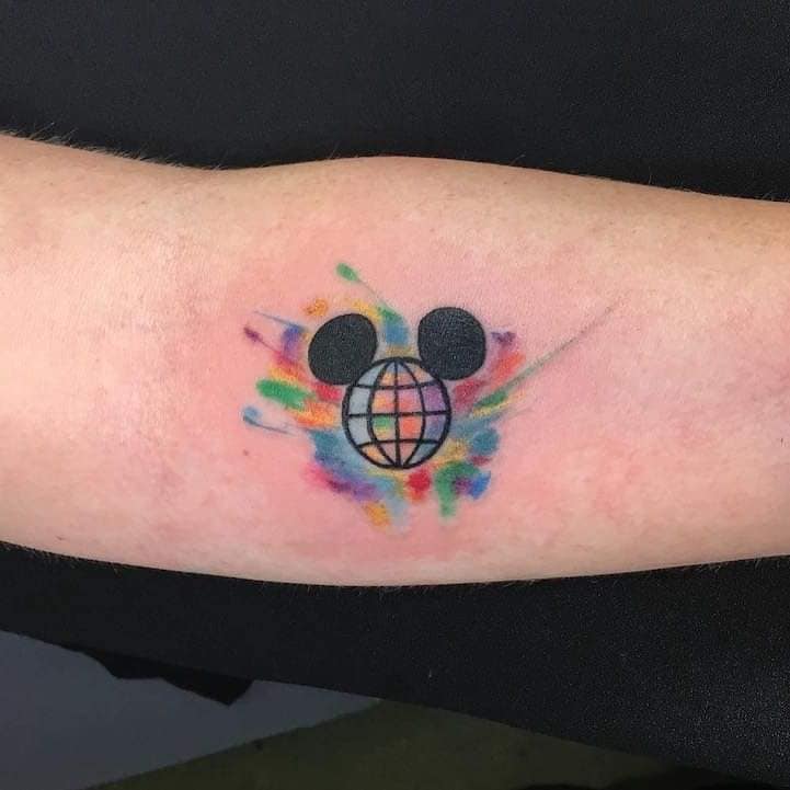 37 Mickey tattoos on the forearm with the logo of the world and colored watercolor on the back