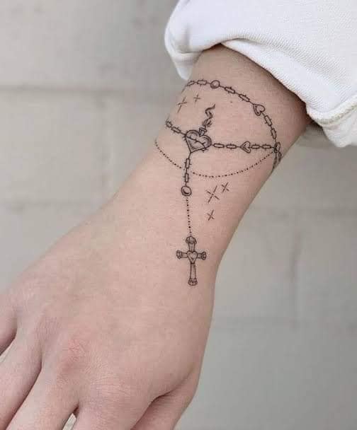 61 Tatuajes de Rosarios tipo pulsera con estrellas cadenitas y cruz en la mano