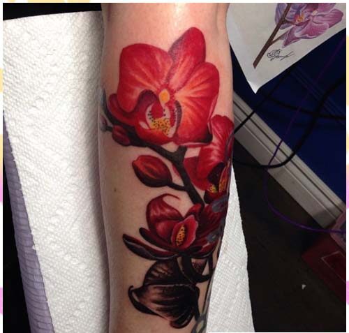 12 Beautiful orchid tattoo on the forearm in wine-colored tones