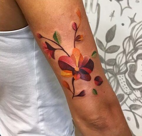 13 Beautiful orchid tattoo on the forearm in cheerful tones