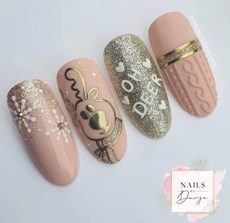 33 Fake pink beige Christmas nails with gold reindeer and snowflakes