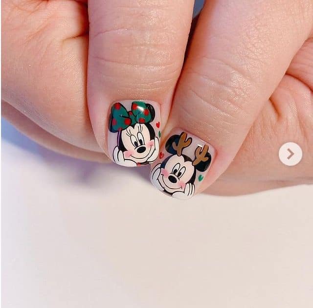 41.2 Mickey and Minnie manicure on Mickey and Minnie thumbs dressed as Christmas reindeer