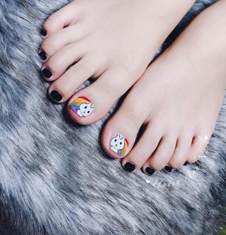 5.12 Pedicure for girls. of a white kitten in a rainbow and black enamel