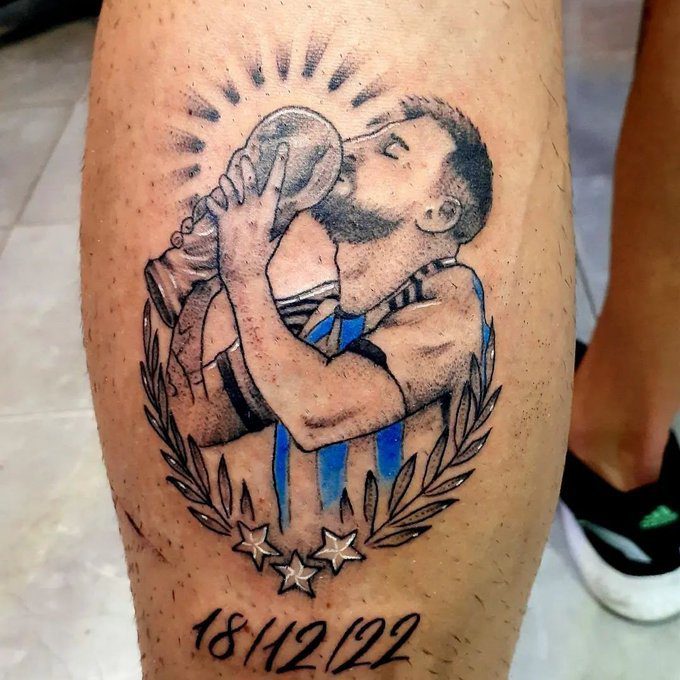 72 Tatuajes de la Seleccion Argentina Campeona Messi besando la copa con aureola de divina fecha colore azul en pantorrilla
