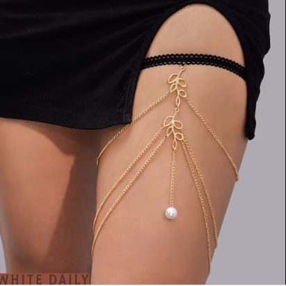 30 Body Chains type leg chains with black ribbon fastener around the leg thin triple chain hanging in the shape of an inverted V with a leaf-shaped pendant in the center and chain hanging with pearl