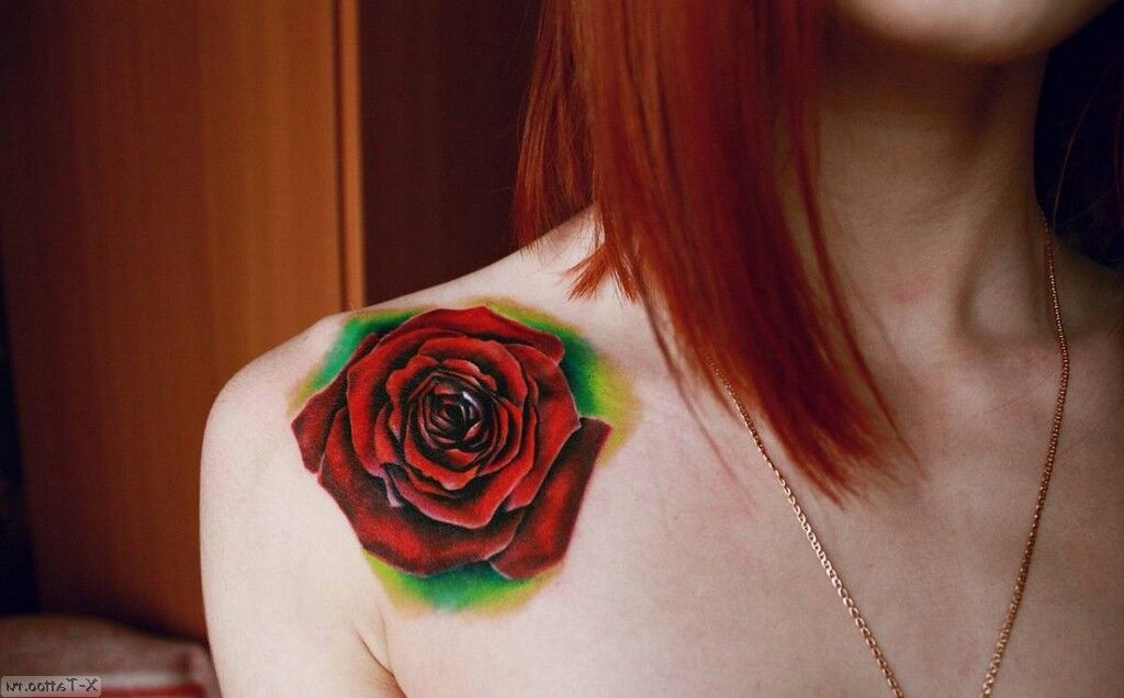 Red rose on woman's shoulder
