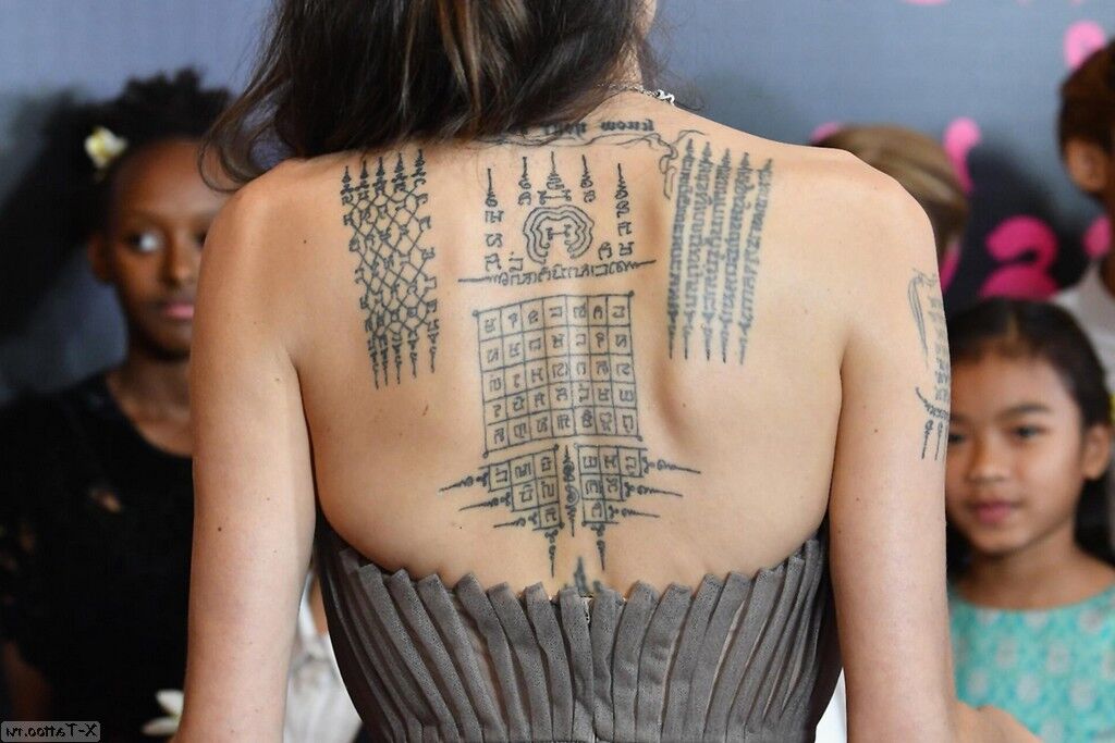 tattoo on the back of Angelina Jolie Patterns Inscriptions Bello