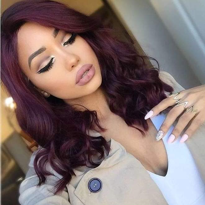 Wavy red wine hair with curlers at the ends