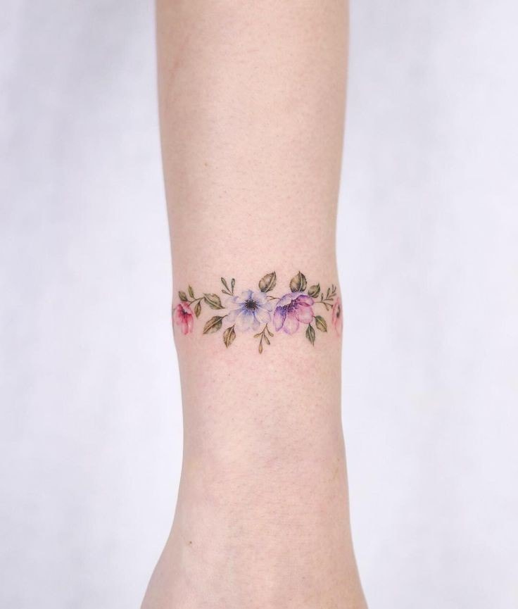 Flowers and branches on the forearm of a woman type bracelet around the wrist violets 16 4