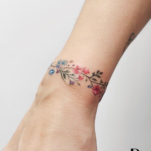 Flowers and branches on the forearm of a woman type bracelet on the wrist 11