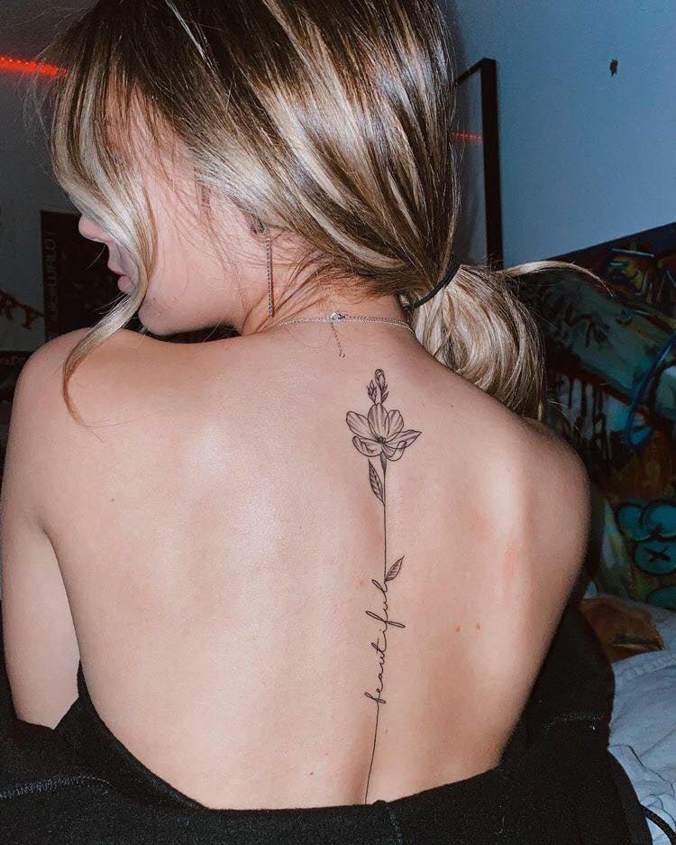 Small delicate flower tattoo on the back 135