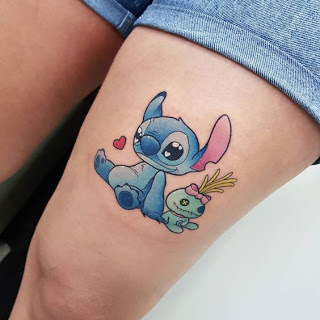 Stitch Ohana tattoo on thigh along with his doll