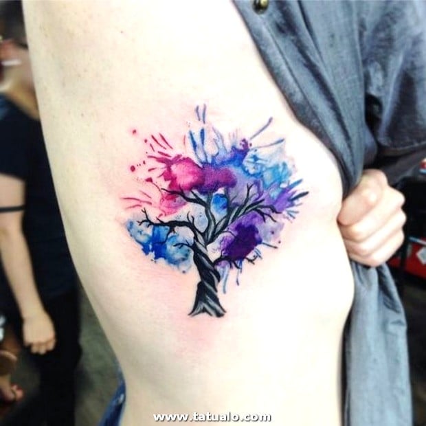 Watercolor Tree of Life tattoo on the side of the chest