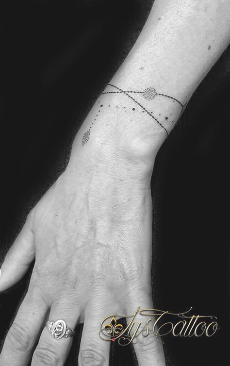 Tätowierung eines Armbands oder Armbands aus feinen Ketten mit Kugeln am Handgelenk