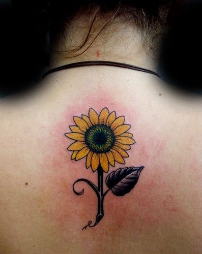 Sunflower tattoo on the back under the neck