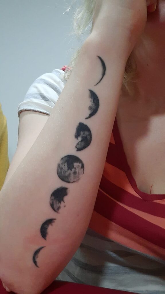 Moon moon phases tattoo on forearm