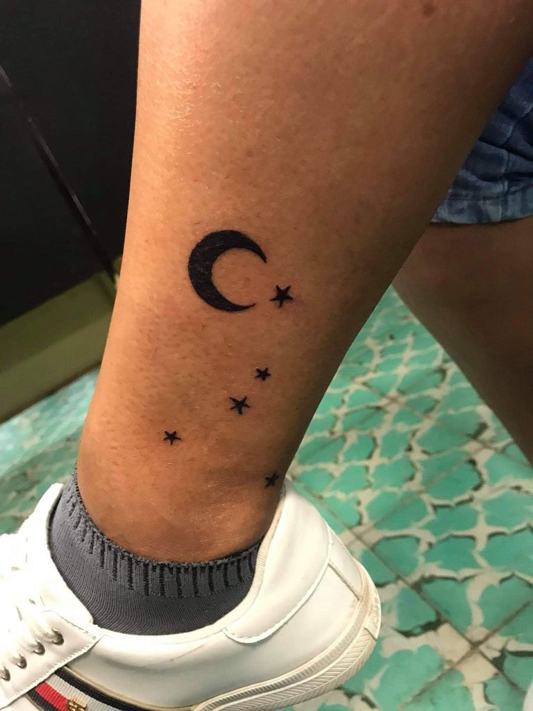 Moon and stars tattoo on ankle and leg