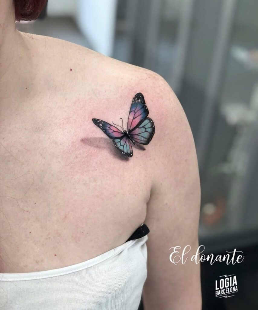 Blue and pink 3D butterfly tattoo on shoulder