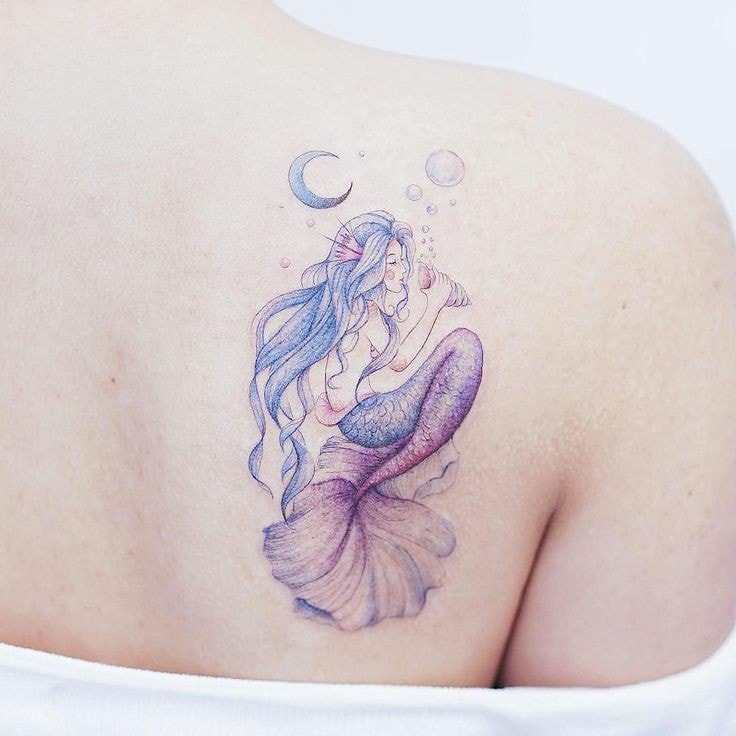 Mermaid tattoo on shoulder blade
