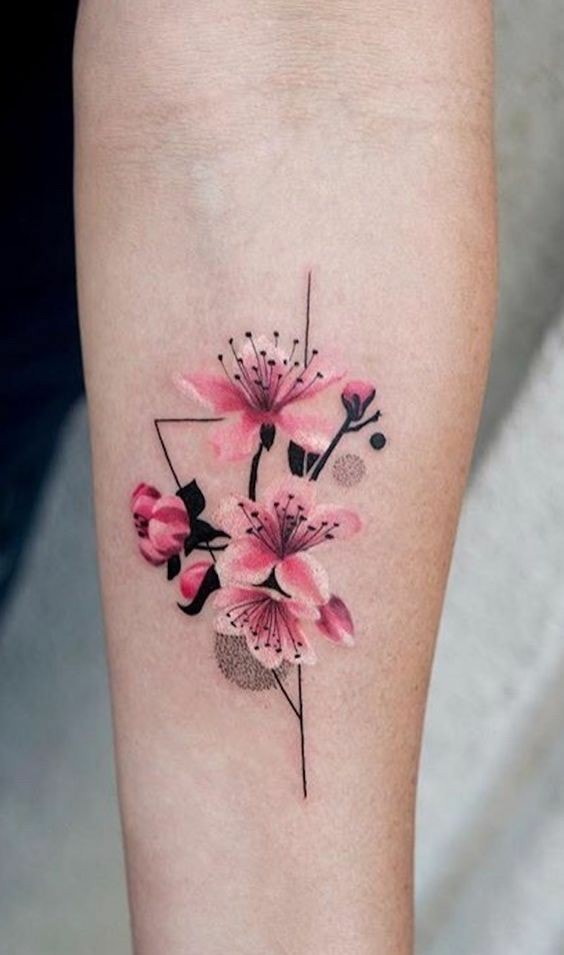 Delicate tattoo of triangle flowers and pink and black flowers