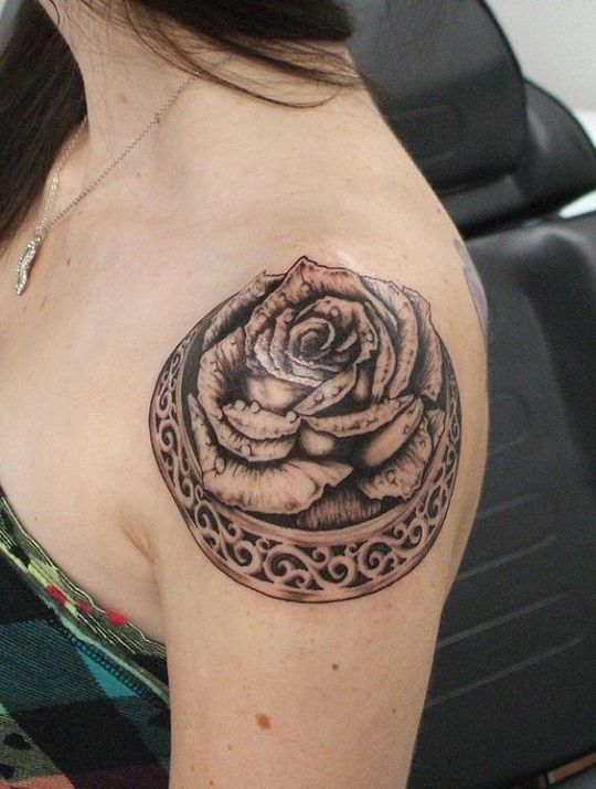 Tattoo on the Shoulder Woman Black Rose inscribed in a kind of crown