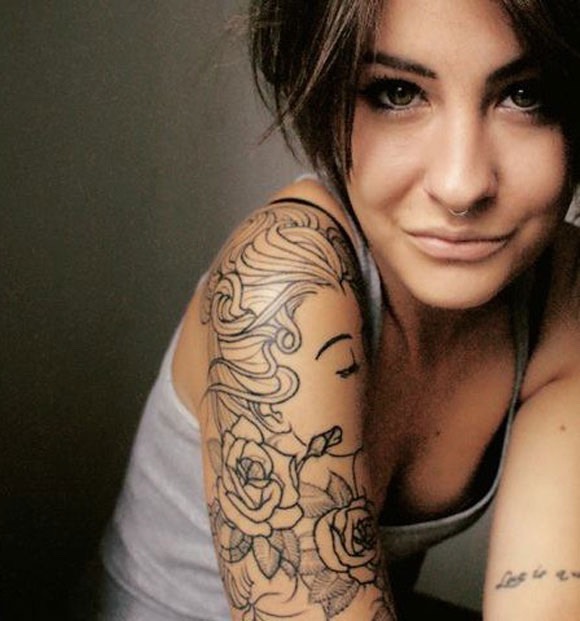 Tattoo on Shoulder and Forearm Woman Outline of woman's face with Roses