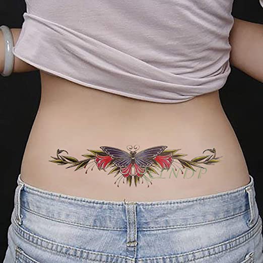 Lower Back Tattoos Woman butterfly moth with red flowers and green branches