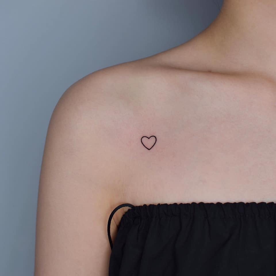 Tatuaggi minimalisti a cuore super piccolo sulla clavicola