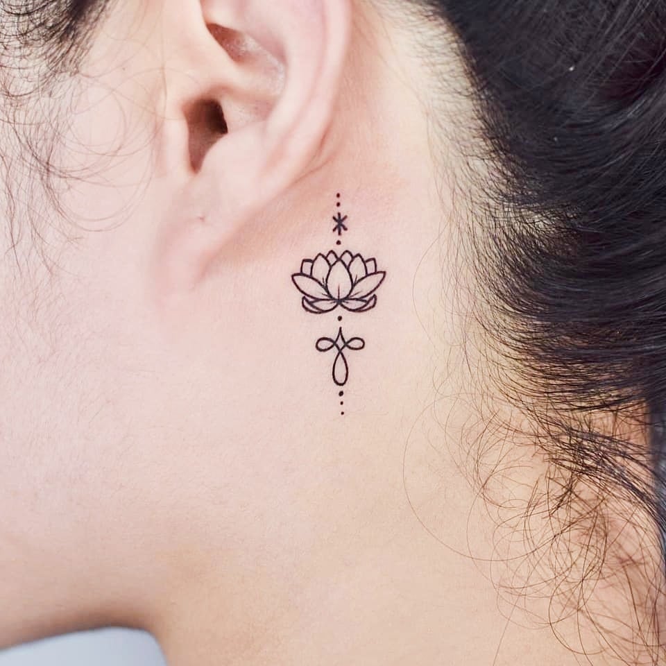 Super Small Minimalist Tattoos Lotus flower behind the ear