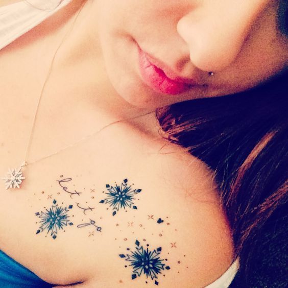 Christmas tattoos snowflakes on shoulder with letters