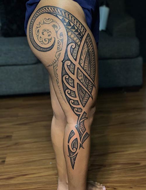 Tribal tattoos on the entire leg of a woman and thigh