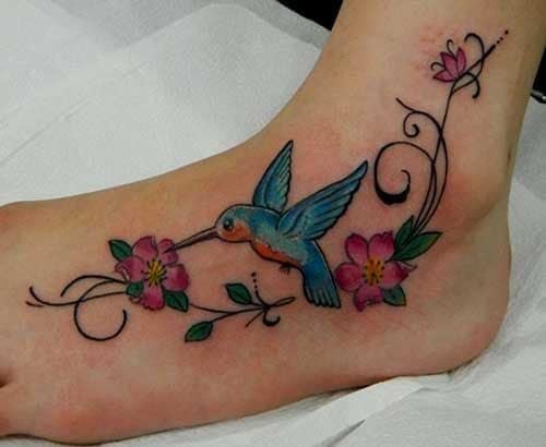 Beautiful tattoos for women hummingbird biting red flower on foot