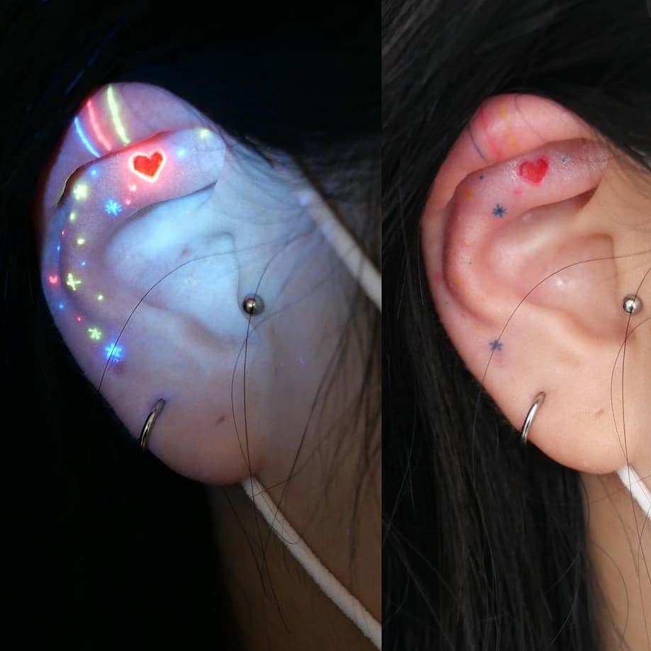 Tattoos with UV Ultra Violet detail on the ear
