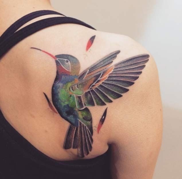 Hummingbird tattoos in large green on shoulder and shoulder blade