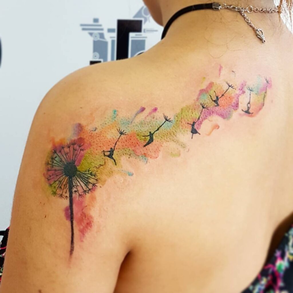 Dandelion tattoos on shoulder and back with men hanging from the seeds that fly