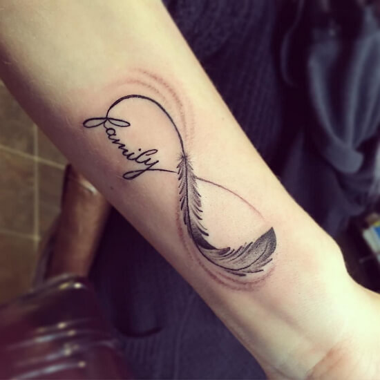 Infinity tattoos with feather on forearm and family