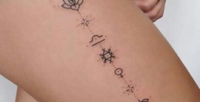 Tatuajes de Libra en muslo con simbolos de flor de loto mujer
