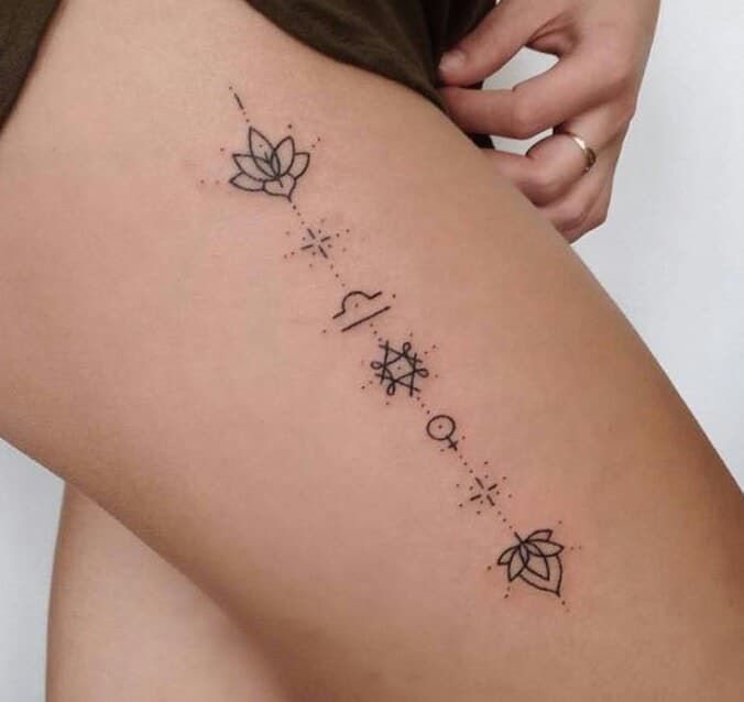 Tatuajes de Libra en muslo con simbolos de flor de loto mujer