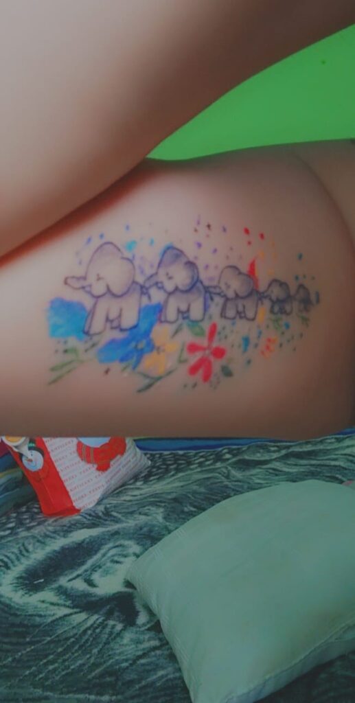 Tattoos of Mothers to Children five elephants with flowers of colors yellow red blue