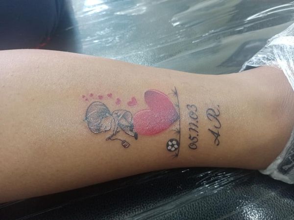 Tattoos of Mothers to Children heart girl date initials on the other wrist